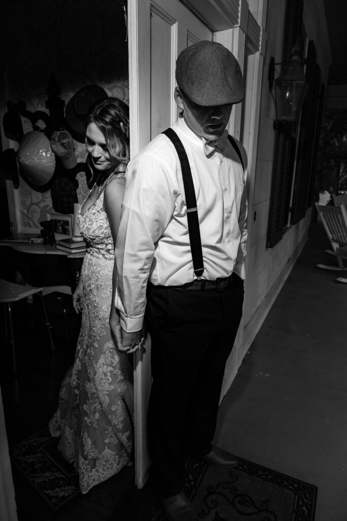 Bride and Groom praying around the corner of a door