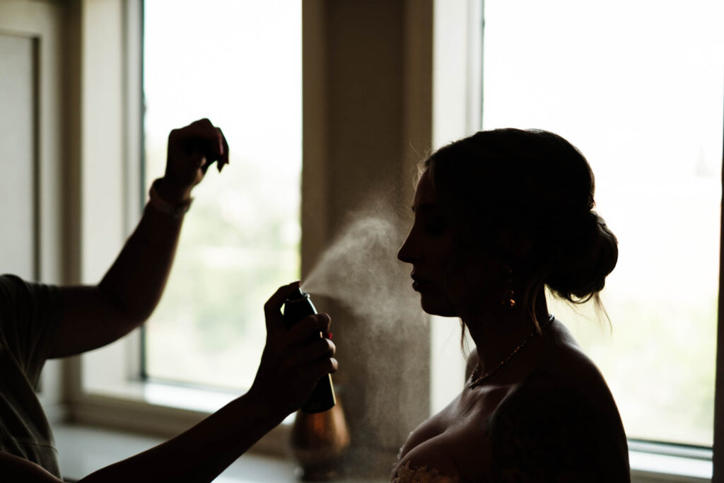 Bride having the finishing touches of makeup applied on the morning of her wedding.